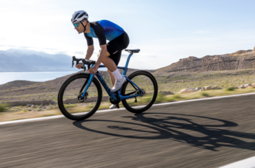 Cyclist riding brand new black 2025 Pinarello Dogma F Launch Edition through mountains.